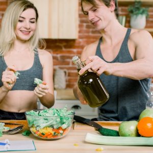 diet, healthy eating, fitness lifestyle, proper nutrition. health conscious couple cooking low