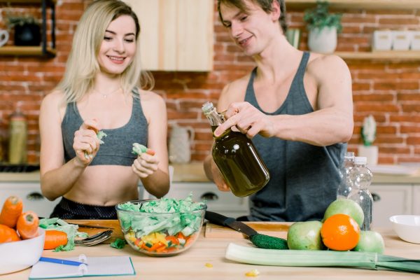 diet, healthy eating, fitness lifestyle, proper nutrition. health conscious couple cooking low